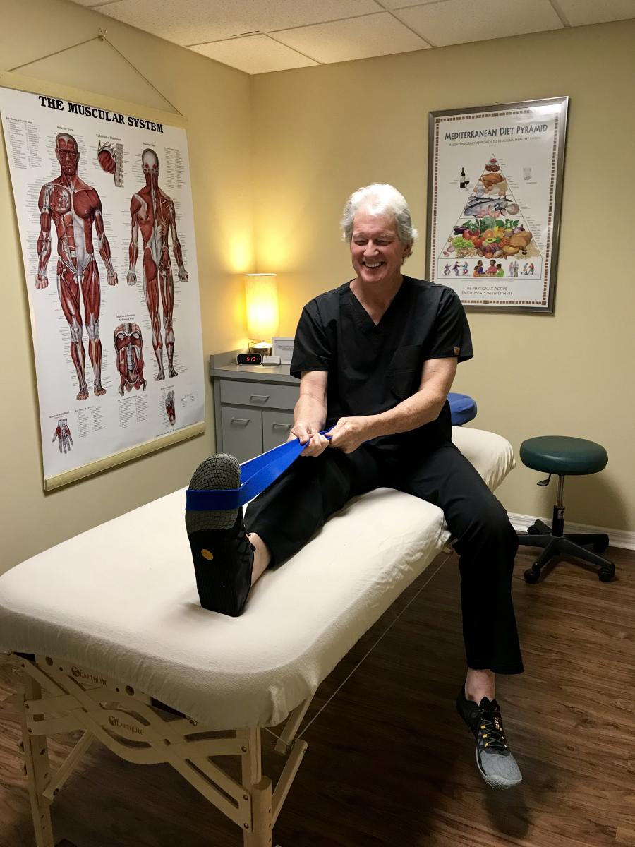 Phelps stretching his calf with the "traveler's best companion" – a yoga strap (Photo: Liz Sandburg)