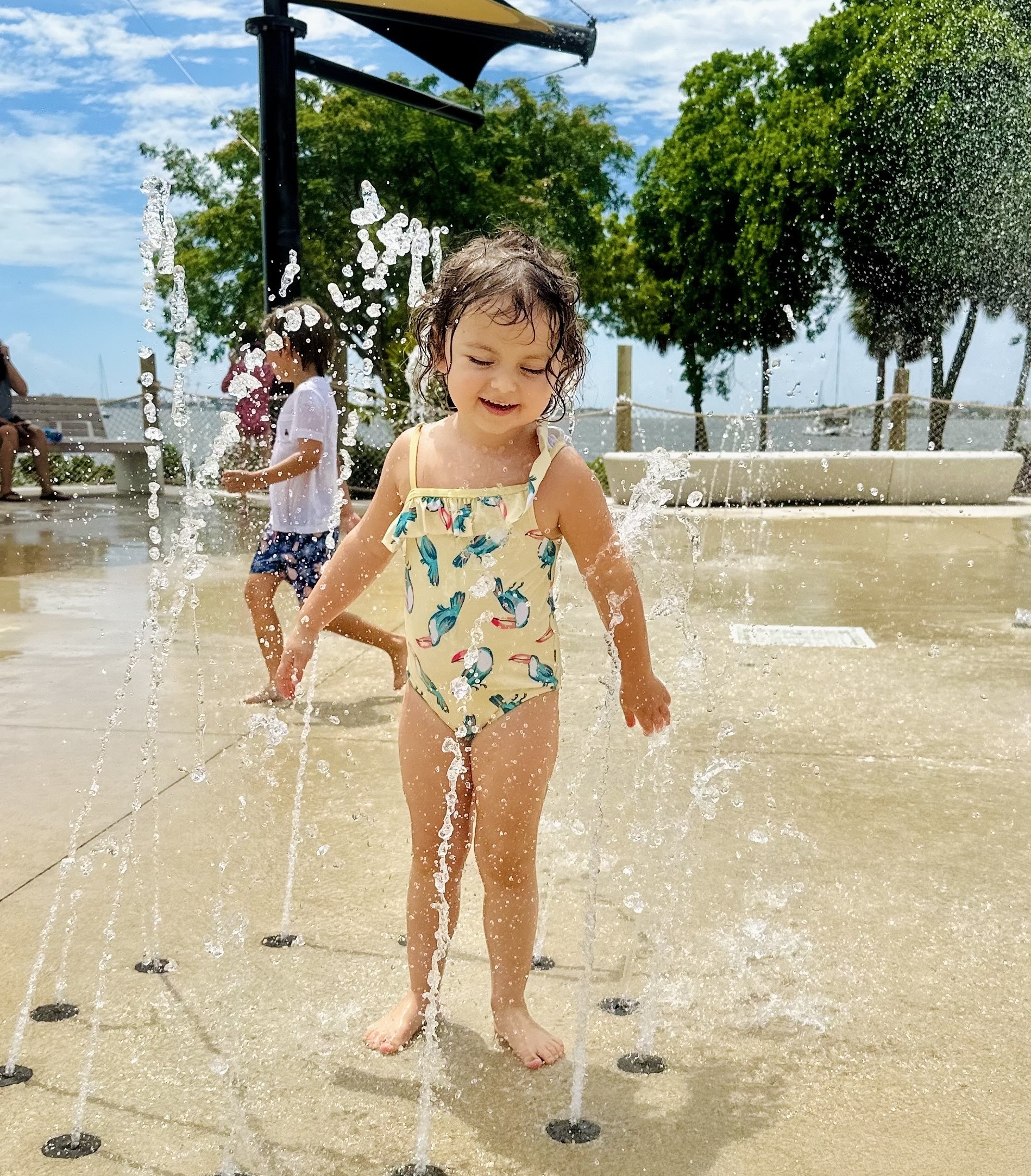 little girl getting wet at splash park in sarasota fl