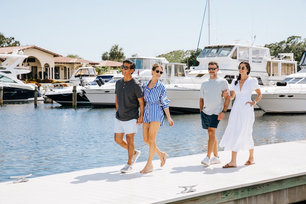 two couples walking the boat docks of longboat key