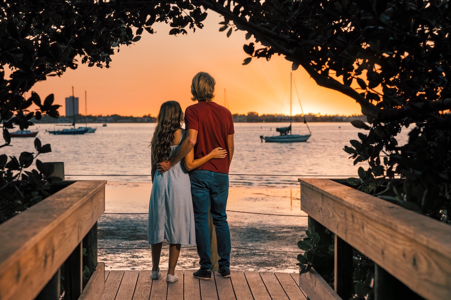 young couple watching the sunset at selby gardens