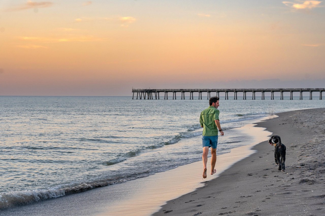 guy running with dog on brohard park