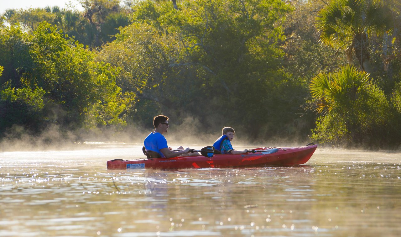 dad and son kayaking in sarasota