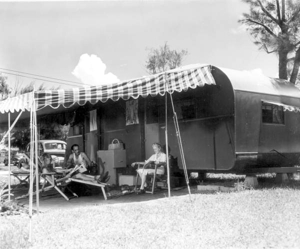 man and woman sitting outside a trailer in sarasota florida