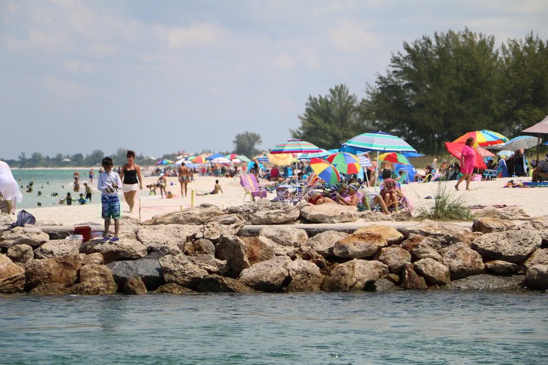 kids playing at the south jetty on nokomis beach in florida