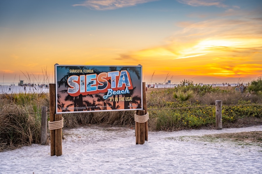 siesta beach sign at sunset