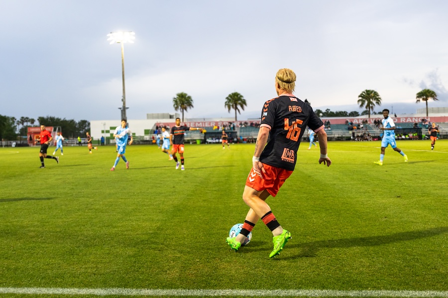 soccer player kicking ball