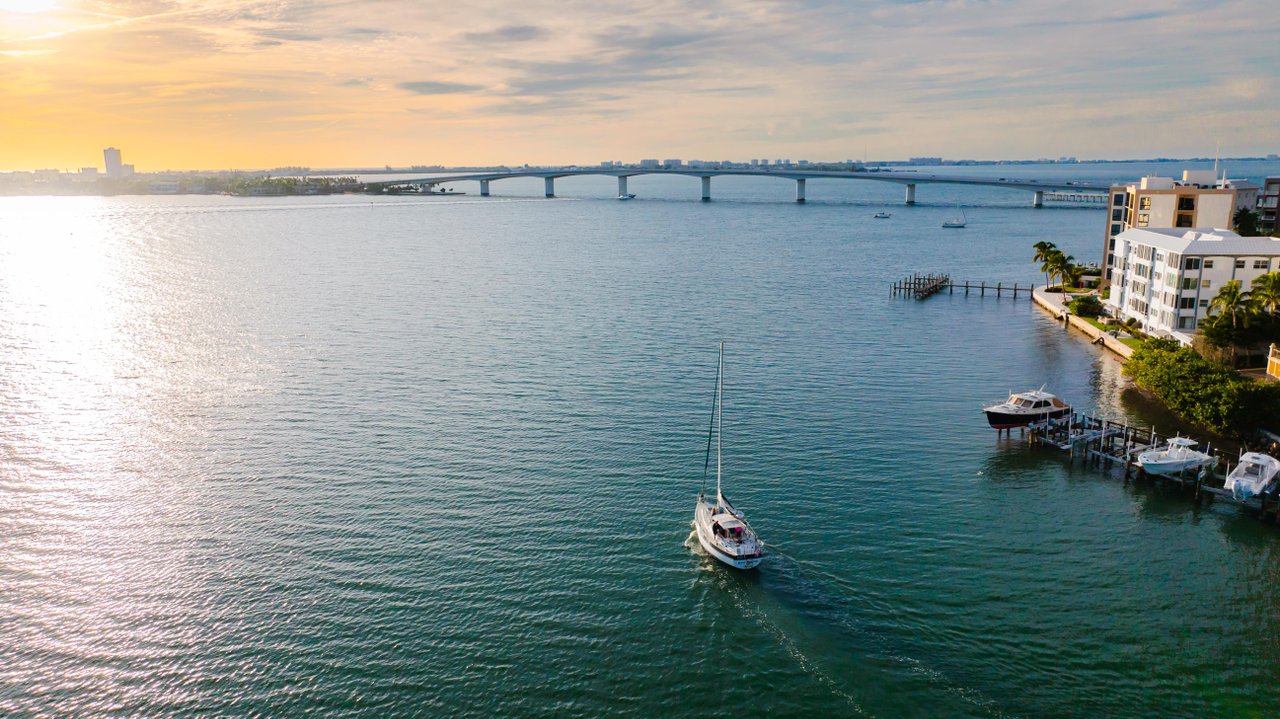 sailboat sailing into sunset on sarasota bay