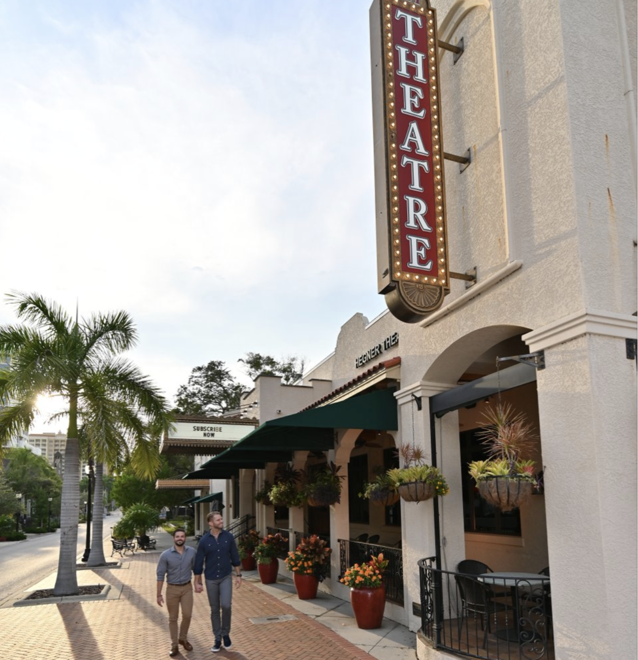 two men walking together out of a sarasota theater