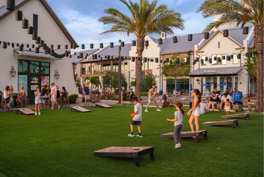 kids playing cornhole outside in lakewood ranch