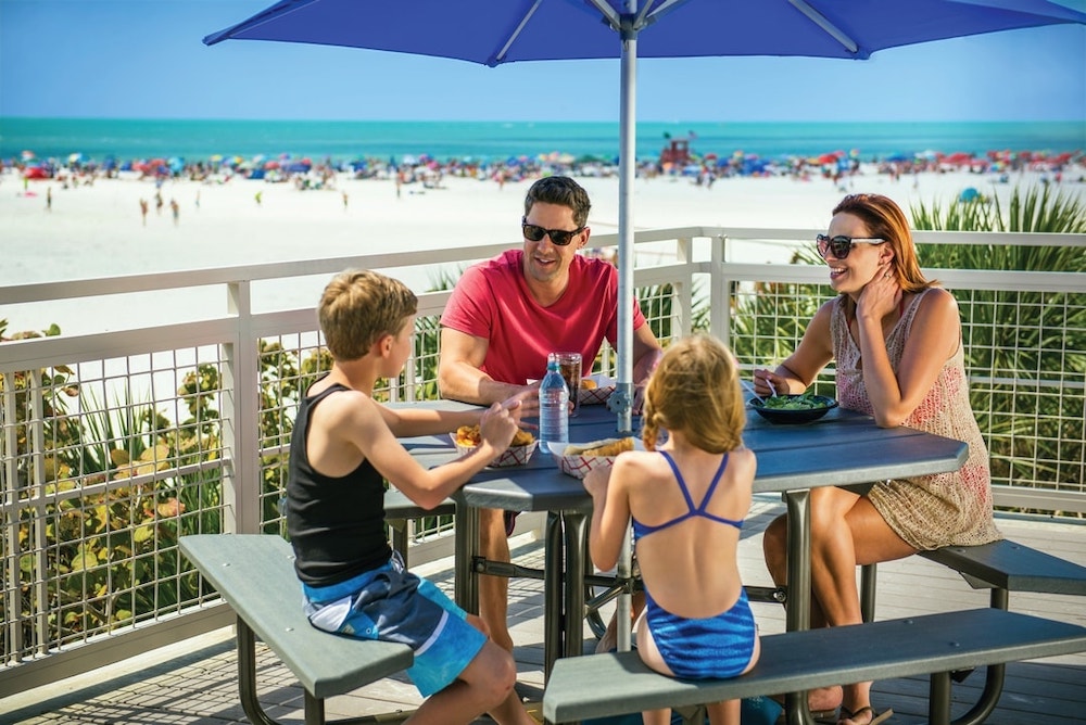 family eating lunch out on siesta beach