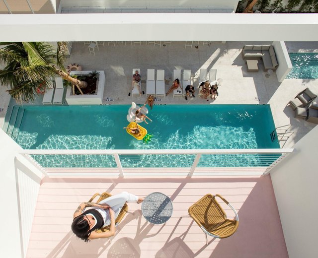 people hanging outside sarasota modern hotel and pool