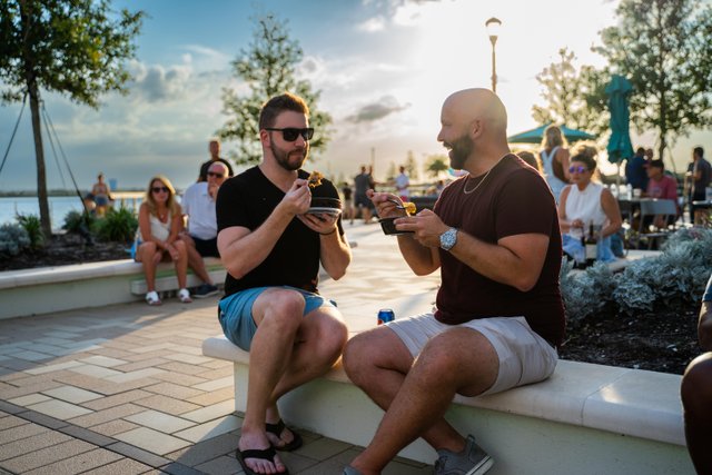 guys eating food at waterside place fl