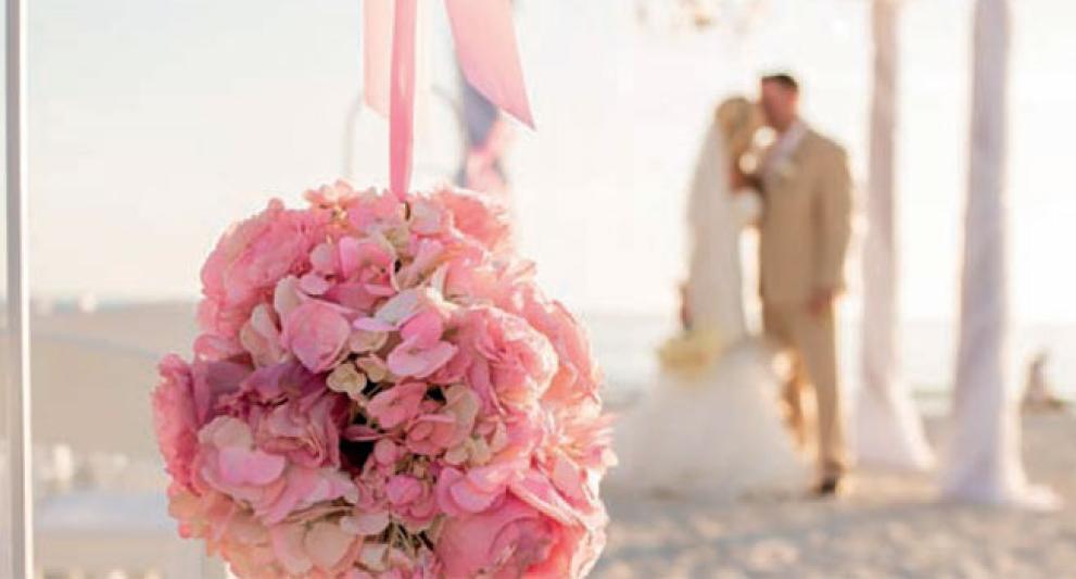 couple kissing on the beach for a wedding ceremony