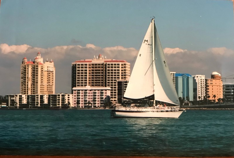 Key Sailing's Key Breeze sailboat cruising Sarasota Bay with the downtown skyline behind it.