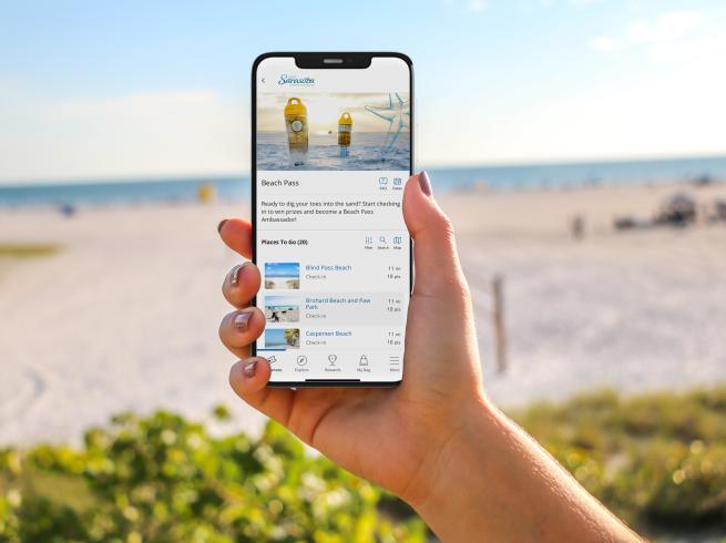 Person holding phone with Beach Pass