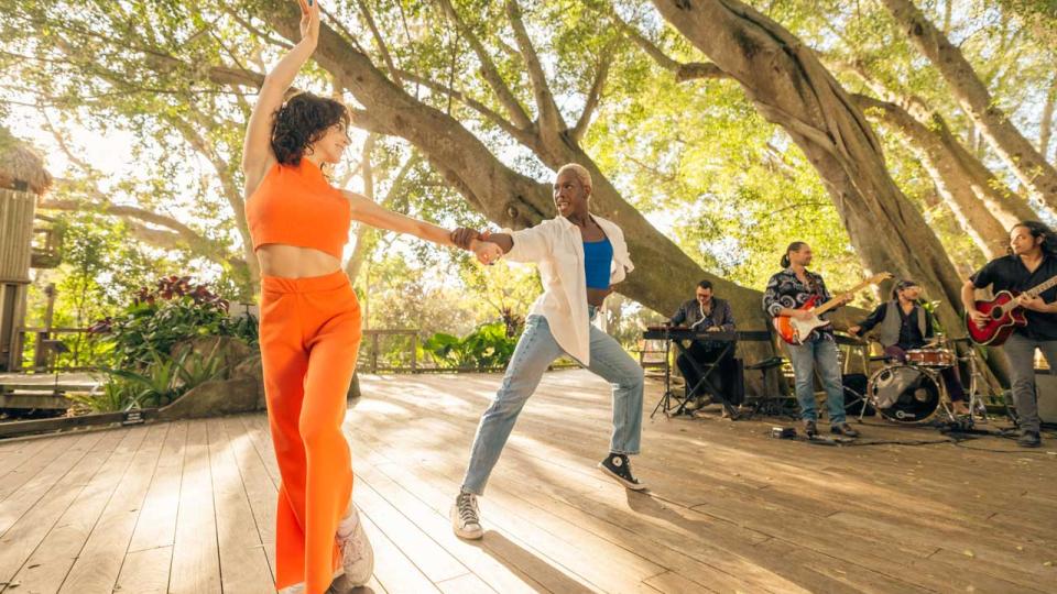 Couple dances under the trees at Selby Gardens