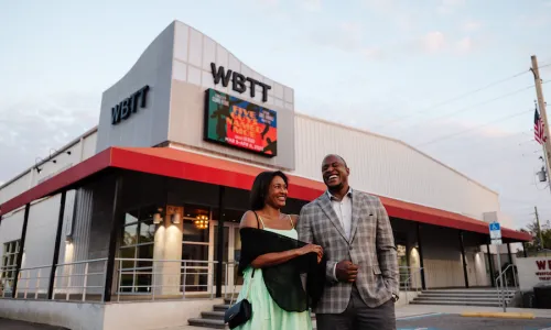 couple outside of west coast black theatre for a holiday show