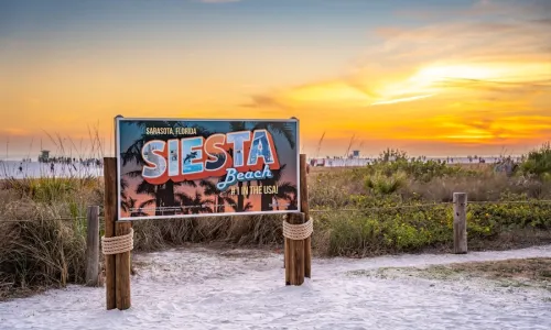 sign on siesta key beach at sunset