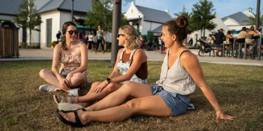 Women sitting on the grass at Waterside Ranch