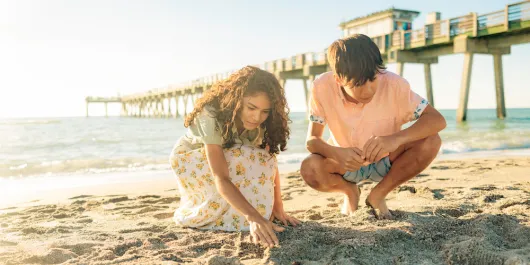 Kids looking for shells and shark teeth at Venice Pier