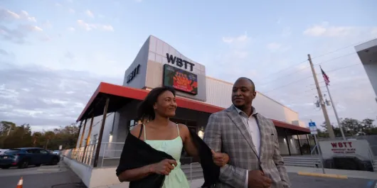 couple outside of west coast black theatre for a holiday show