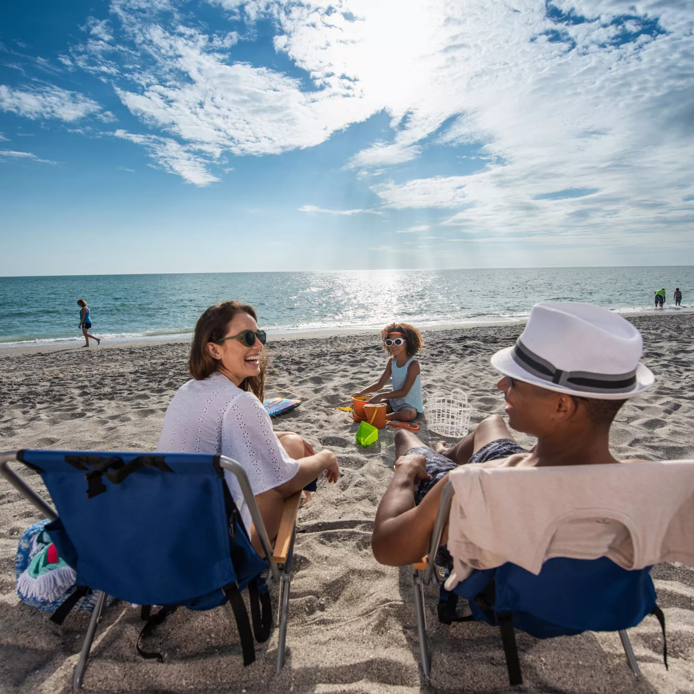 Couple on beach chairs looking out at the ocean