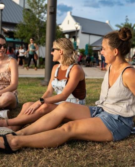 Women sitting on the grass at Waterside Ranch