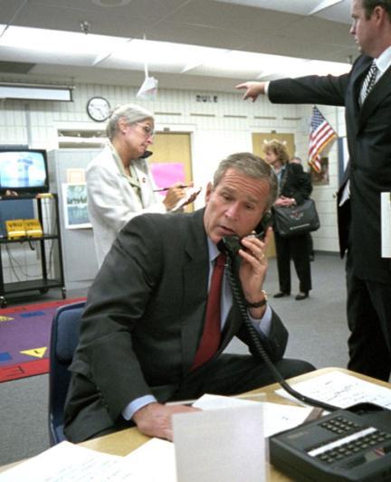 George Bush gathers information about the 9/11 attacks in a classroom at Emma E. Booker Elementary School in Sarasota on Sept. 11, 2001 [Photo: The U.S. National Archives]