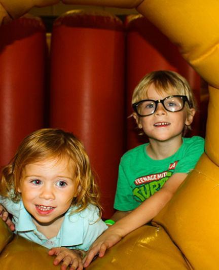 A very young boy and girl enjoying themselves at Bounce Down Under. Photo by Liz Sandburg