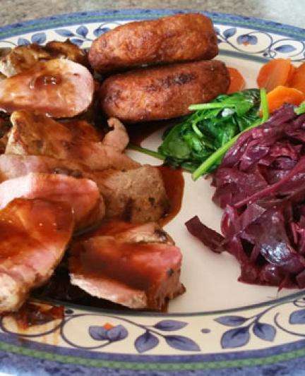 Grilled pork tenderloin with Madeira wine sauce, fruit chutney, sweet potato pancakes, braised red cabbage, garlic spinach and carrots.  Photo Credit: Abby Weingarten.