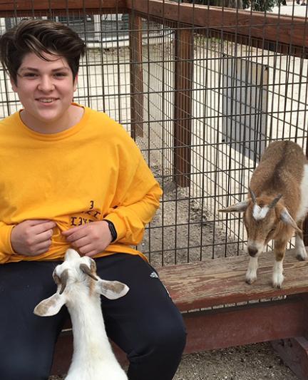 Petting the goats at Big Cat Habitat & Gulf Coast Sanctuary. Photo by Vanessa Caceres.