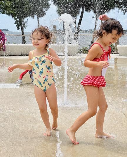 little girls playing in the fountains of a sarasota park