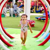 Girl running through water at Payne Park