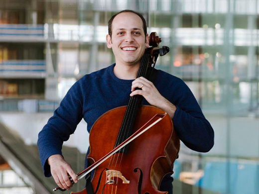 Cellist posing with his cello