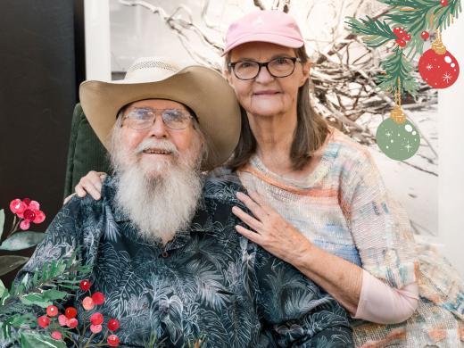 Clyde and Niki Butcher with Christmas graphic