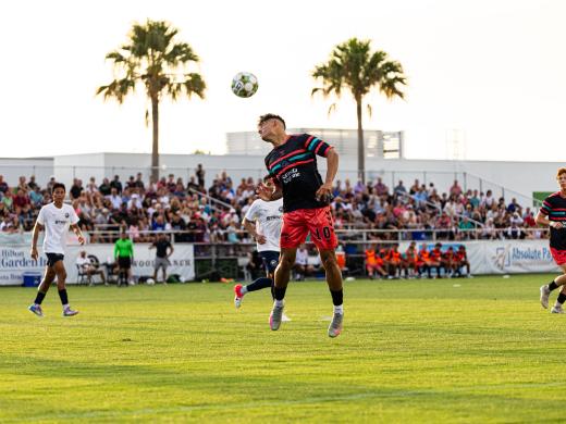 Paradise player heading a ball