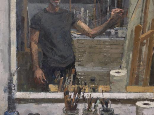 Portrait of a man painting on a canvas 