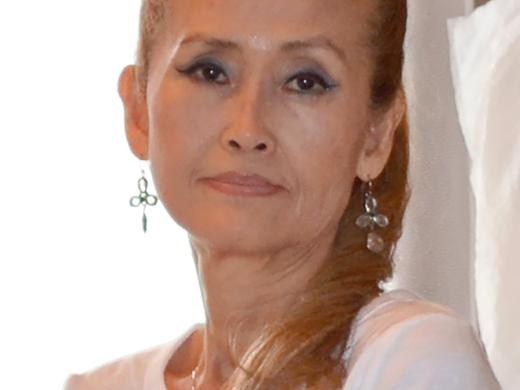 Artist Herion Park's headshot, wearing white shirt, ponytail, and earrings.