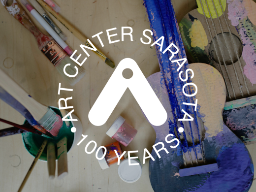 image of a cardboard guitar, half painted, with Art Center Sarasota logo