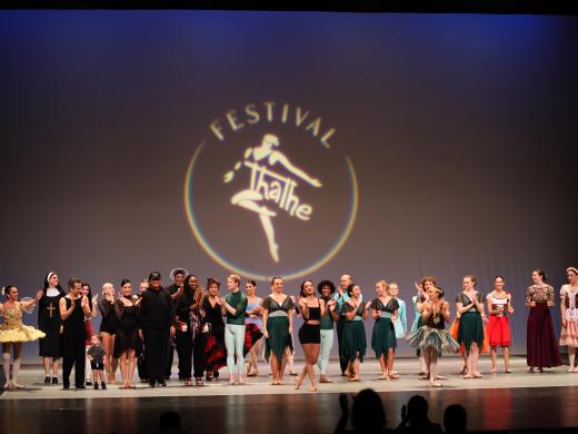 Adult dancers performing on stage at the Thalhe International Dance Festival at Sarasota Opera House.