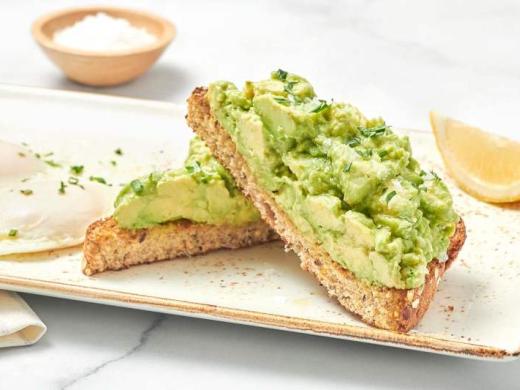 Avocado Toast - Thick-cut whole grain artisan toast, fresh smashed avocado, EVOO, lemon and Maldon sea salt with two cage-free basted eggs. Photo 3