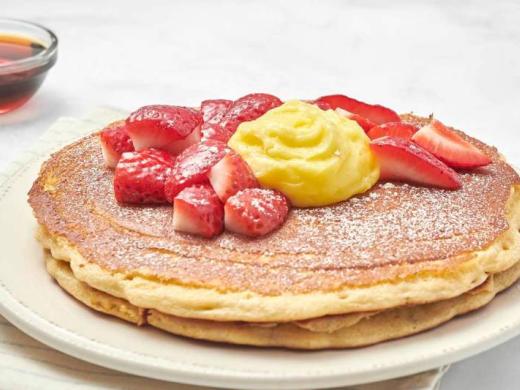 Lemon Ricotta Pancakes - We add fresh, whipped ricotta cheese to our multigrain batter. Served as a "mid-stack" of two pancakes topped with berries, creamy lemon curd and powdered cinnamon sugar. Photo 5