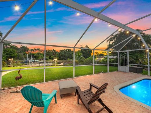 Gulf Tide - Fully renovated home with vibrant gourmet kitchen, situated directly on a quiet canal, with large screened-in pool and patio for entertaining or relaxing. Photo 6