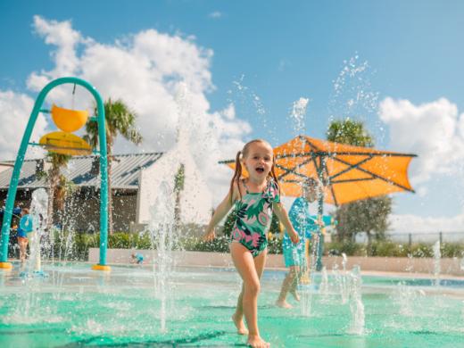 Waterside Park Splash Pad - Kid playing at the Waterside Place Park Splash Pad Photo 5