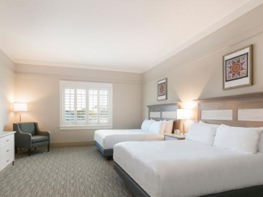 Standard Double Queen - Enjoy cozy beds, handcrafted details, quilts and one-of-a-kind décor. Our spacious Standard Double Queen Rooms include 2 Queen Beds, 1 small table with 2 chairs, separate d... Photo 7