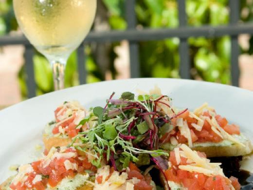 Goat Cheese Bruschetta - marinated tomatoes, fresh basil-pesto goat cheese, aged Parmesan, grilled rustic bread, basil olive oil, aged balsamic drizzle Photo 3