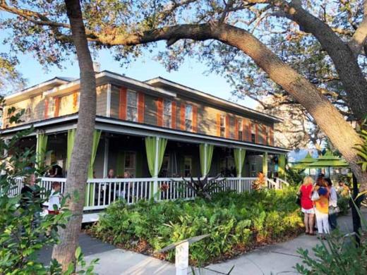 Towles Art Center Porch - Three restaurants at Towles! Bodhi Tree Cafe (here on the porch of the Art Center) Shoogie Boogie Garden Cafe (on the courtyard) and Indigenous (located at Links and Adams) Photo 7