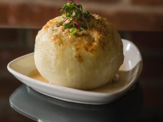 Signature French Onion Soup - Our signature French Onion Soup is served in a whole onion, taking the classic onion flavor to another level. Photo