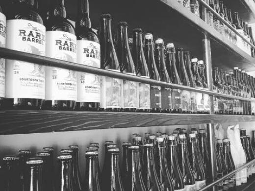 99 Bottles Taproom & Bottle Shop - shelves full of a well-curated selection of exceptional craft beer... Photo