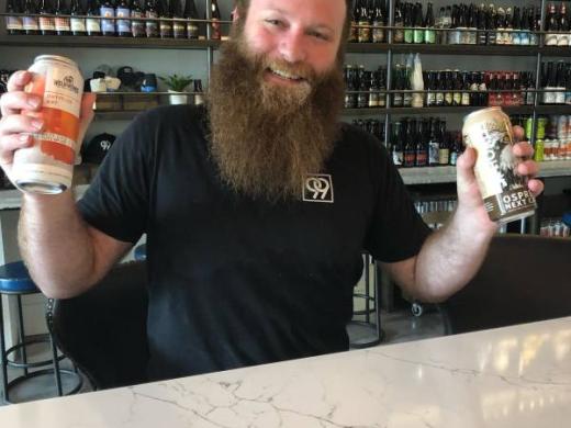 99 Bottles Taproom & Bottle Shop - swing by for a pint of beer, a glass of wine, and a bite or snack...
you'll be just as happy as this guy! Photo 15